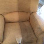 Upholstery cleaning showing a clear divide between the cleaned and dirty sections on a beige armchair